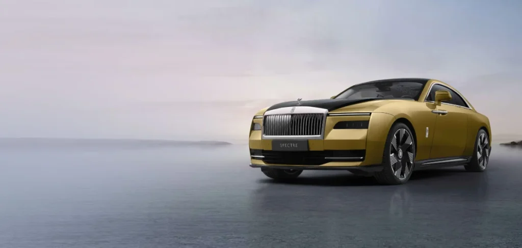 A luxurious gold-coloured Rolls-Royce Spectre car parked