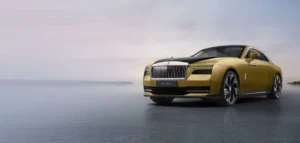 A luxurious gold-coloured Rolls-Royce Spectre car parked